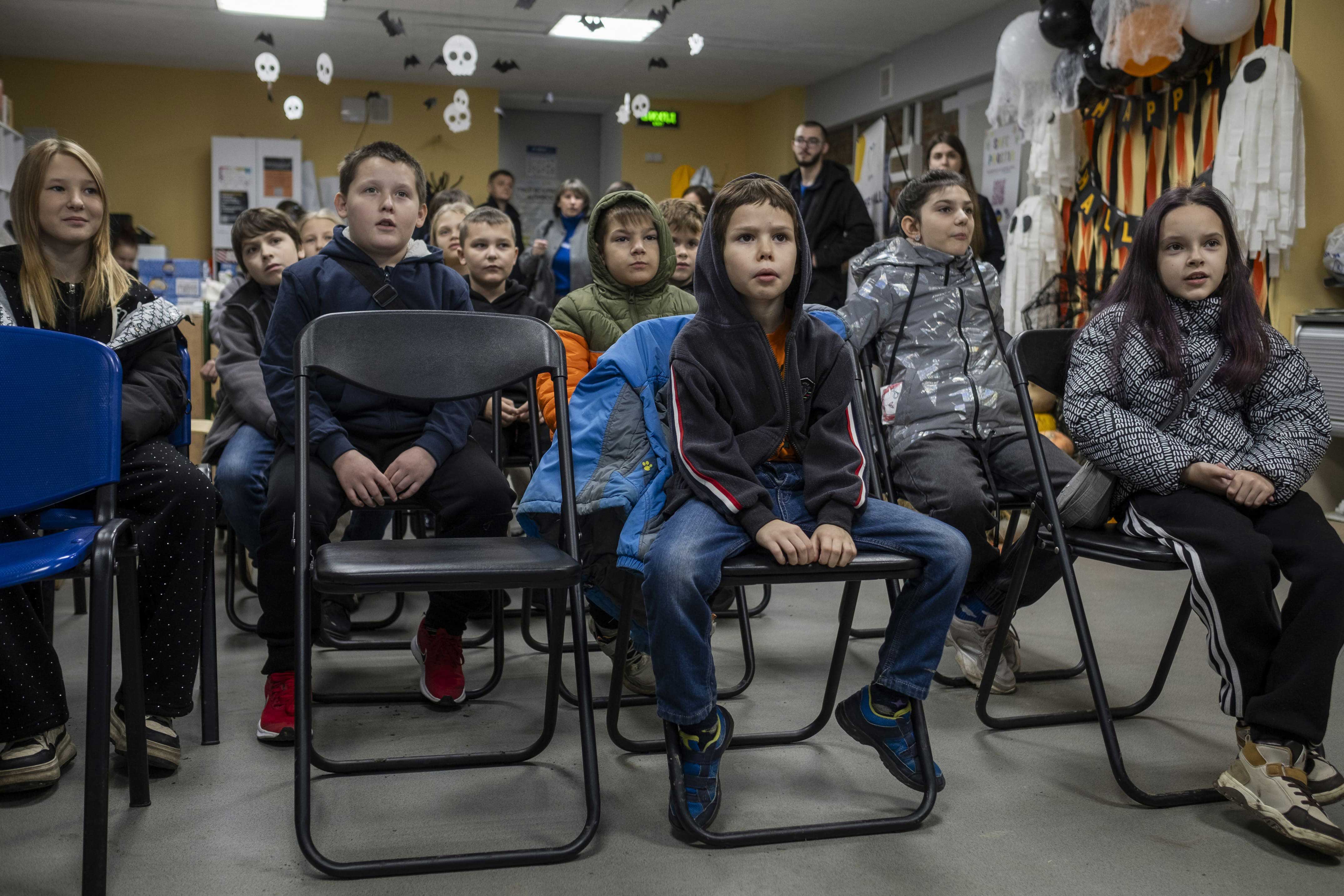 Des élèves de primaire du lyceum 5 d’Izioum regardent un dessin animé sur le danger des mines lors d’une session d’EORE de la FSD, le 29 octobre 2025.